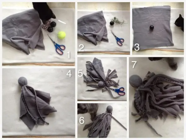 Graues Katzenspielzeug wird aus Stoff und anderen Materialien gestaltet, während eine Hand dabei die Schere hält.