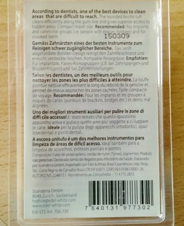 Eine Einbüschelbürste liegt in einer durchsichtigen Verpackung, beschrieben als ideal zum Reinigen schwer erreichbarer Zahnflächen.