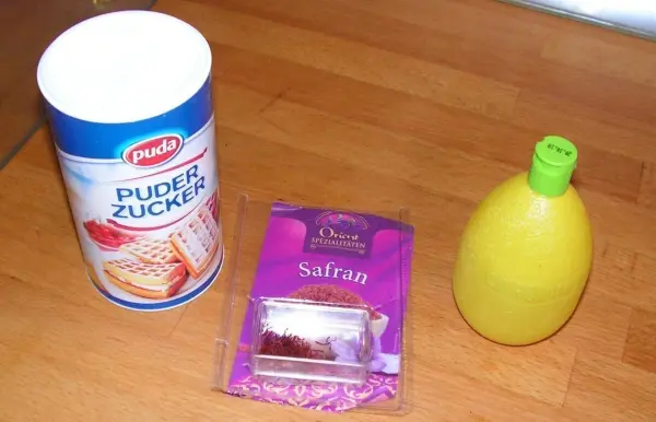 Zucker, Backzutaten und Zitronensaft stehen bereit, um köstliche Weihnachtskekse in einer Küche zuzubereiten.