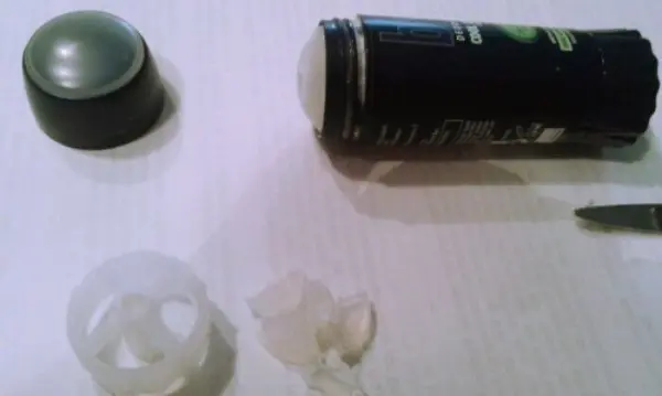 Ein Deostick liegt geöffnet auf einem Tisch, während der Rest des Inhalts ausgekratzt wird, um ihn restlos zu verwenden.