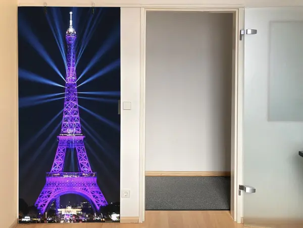 Eine Verdunkelungstür zeigt den Eiffelturm in lila Licht, als stilvolle Raumtrennung in einem modernen Innenraum.