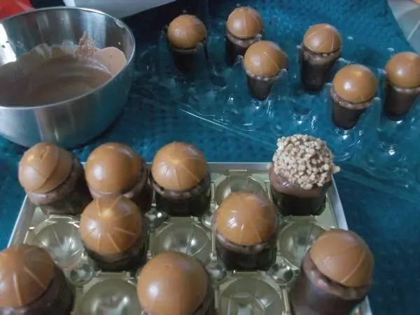 Schaumküsse unten in Schokolade tauchen und ein Toffifee drauf setzen. Mit Toffifee erneut in Schoki tauchen und in Krokant wenden.