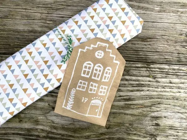 Originelle DIY-Geschenkverpackung mit aufgezeichnetem Lebkuchenhaus.