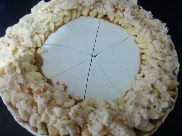 Jetzt entfernt man die mittige Sch&uuml;ssel und schneidet den Teig in der Mitte mit einem Messer in acht gleiche Teile zu.