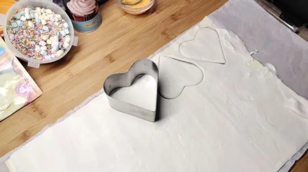 Mit Herz-Servierring (oder Kreis) wird aus den Bl&auml;tterteig-Platten ausgestochen und mit Eigelb bestrichen.