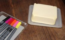 Mit Butter gegen Lackmalstiftflecken auf Holztisch