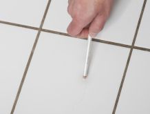 Haarrisse in weißen Wandfliesen kaschieren: mit weißem Kajalstift