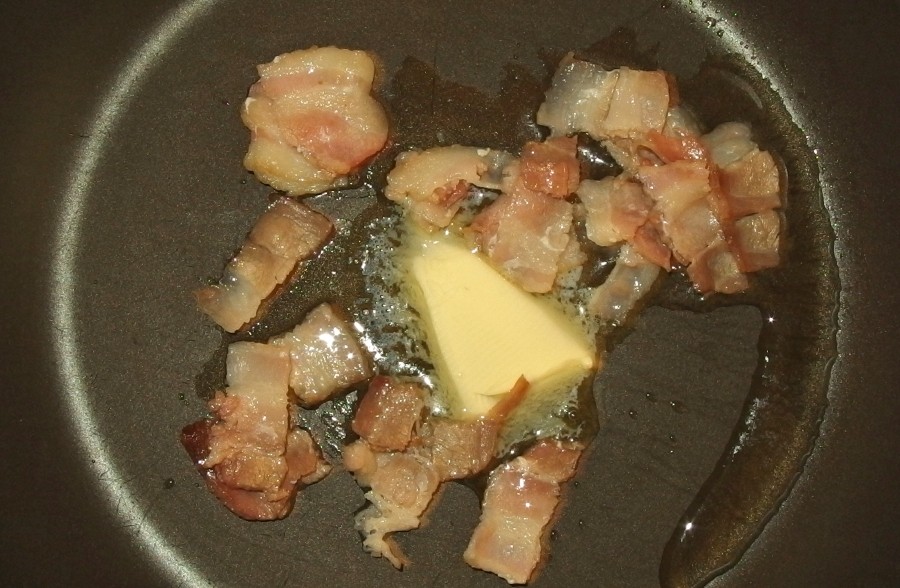 Speckwürfel in eine Pfanne mit Butter (Margarine) geben und kurz anbraten.