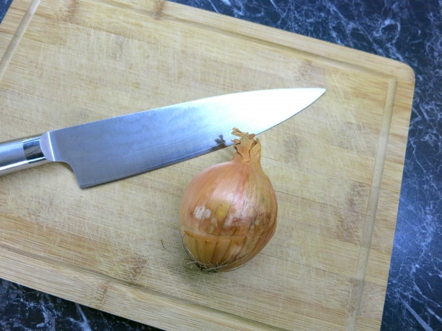 Ohne Weinen Zwiebeln schneiden: Dieser Tipp klappt hervorragend! Das Küchenbrett und das Messer mit Wasser abspülen und dann die Zwiebeln schneiden.