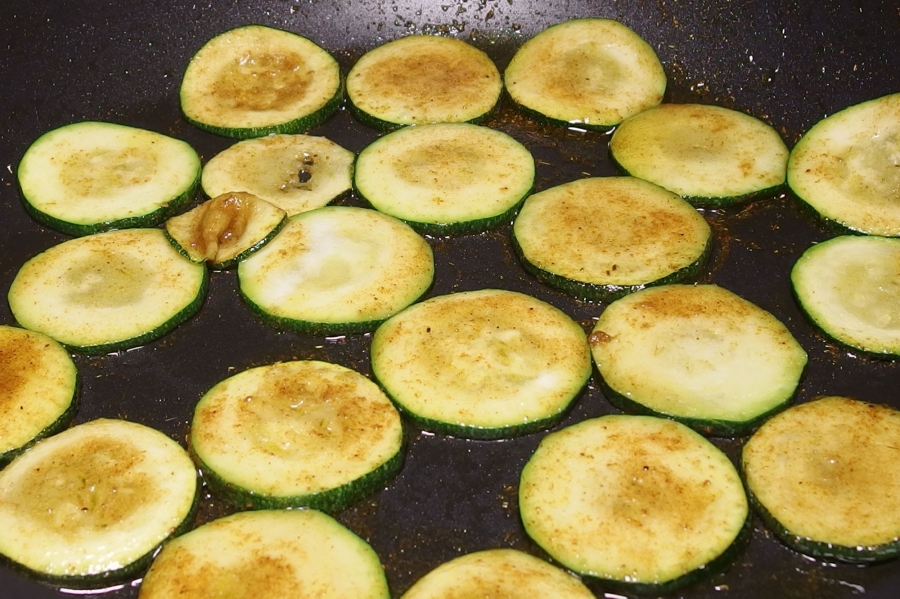 Die in Scheiben geschnittenen Zucchini hinzugeben, 3 Minuten auf mittlerer Stufe anbraten.