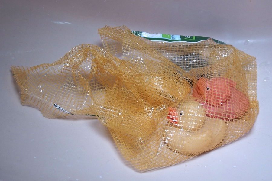 In einem großem Plastiknetz für Kartoffeln, Zwiebeln oder anderes Gemüse aus dem Supermarkt, lässt sich Badespielzeug hervorragend aufbewahren und trocknen.