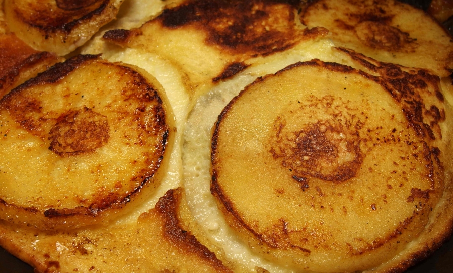 Fertig gebackene luftige Pfannkuchen mit Apfelscheiben. 