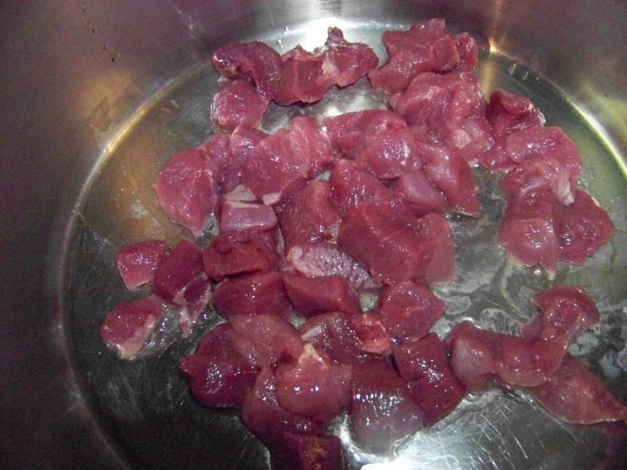 In einem entsprechend großen Topf die Fleischwürfel in heißem Erdnussöl anbraten. Das Fleisch aus dem Topf nehmen. 