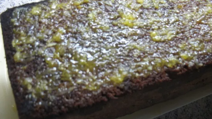 Die Orangen-Zitronensaft-Mischung wird auf der Unterseite des Kuchens verteilt.