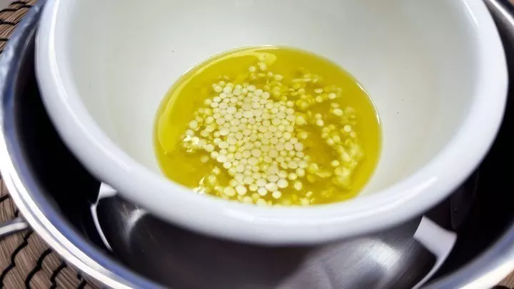 Für den Erkältungsbalsam gibst du zuerst Olivenöl und Bienenwachs in eine Schüssel, die du dann in ein Wasserbad legst.