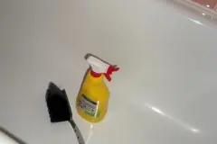 Handfeger zum Reinigen der Badewanne benutzen