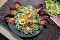 Frittiertes Ei auf frischem Salat